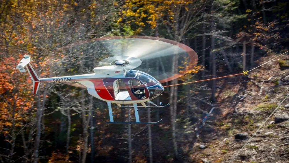 A helicopter flying through a forest